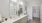 Model bathroom at our apartments in Glen Allen, featuring wood grain floor paneling and a view of the walk in closet.